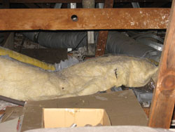 Crushed air ducting in an attic. Heating and air conditioning ducts.