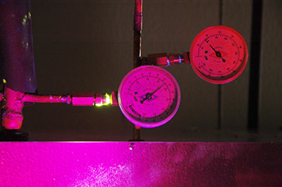 Freon leak exposed under ultra violet light. Freon leak detection experts.