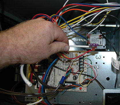 The furnace circuit board controls both the furnace and the outdoor air conditioner